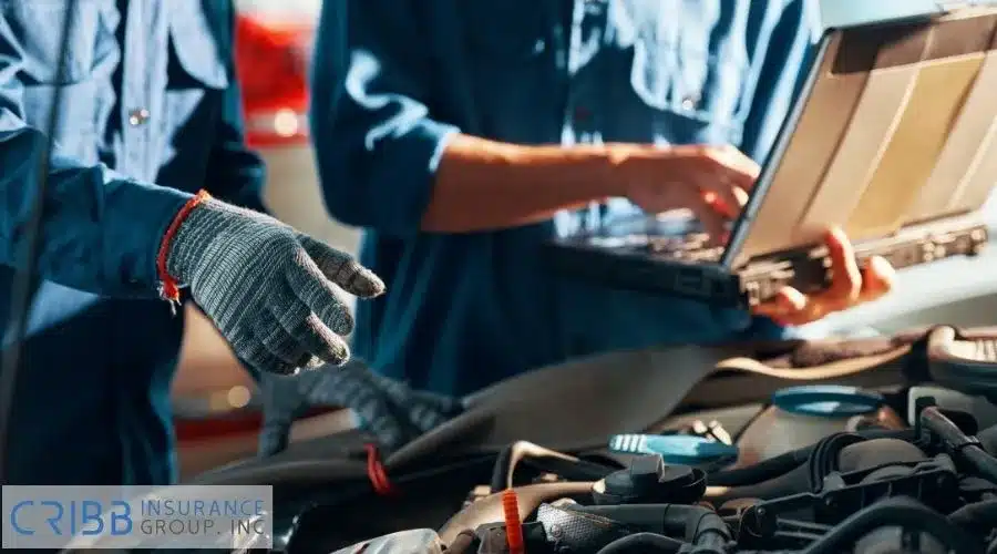 Mechanic repairing a modern car with high-tech diagnostic tools