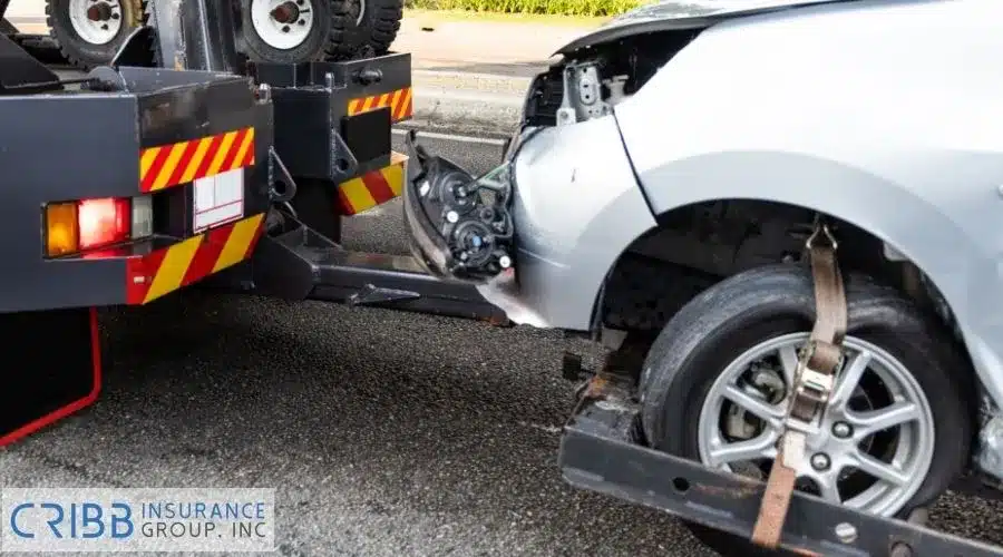 Tow truck towing broken down car from accident